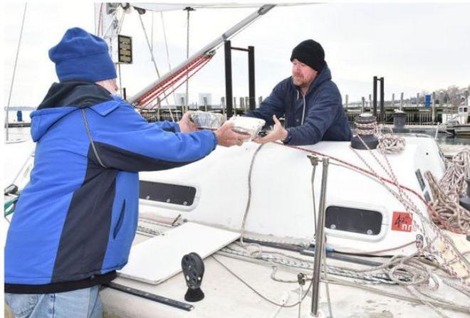 Reg, left, and Jason McGlashan load food aboard Sedona on Saturday at Conanicut Marina in Jamestown. The father and son plan to sail the boat home to Australia - The Newport Daily News © Dave Hansen